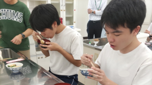 完成した料理を食べる生徒（写真）